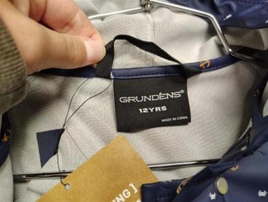 "Grundens" is printed on the label inside the jacket