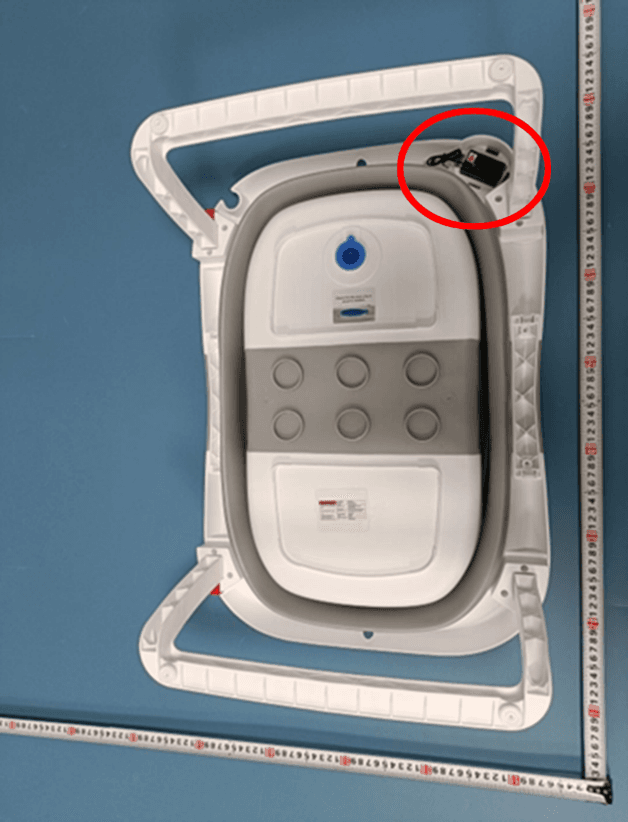 Bottom view of the Recalled Napei Collapsible Infant Bath Tub showing location of battery compartment